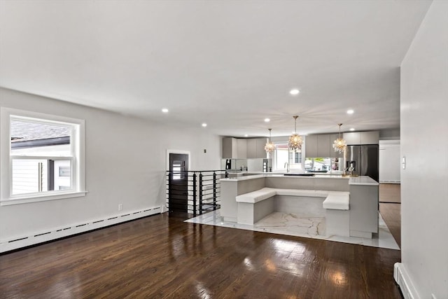 23 Donna St, Westport, MA 02790 - kitchen featuring stainless steel fridge with ice dispenser, wood finished floors, baseboard heating, light countertops, and recessed lighting