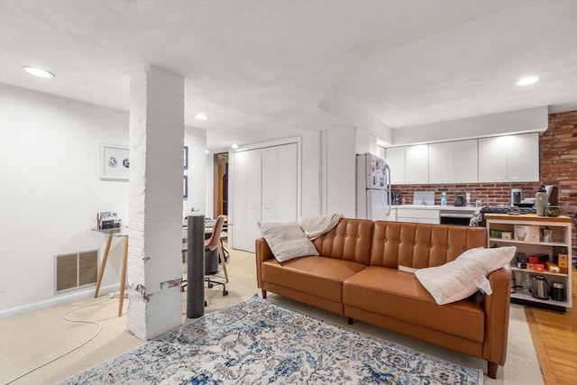 living room featuring baseboards, visible vents, and recessed lighting