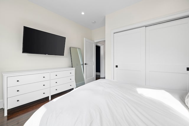 bedroom with a closet and dark wood-type flooring