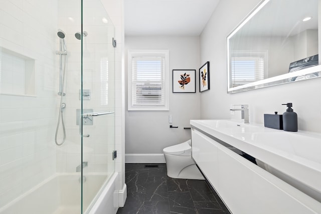 full bathroom featuring vanity, enclosed tub / shower combo, and toilet