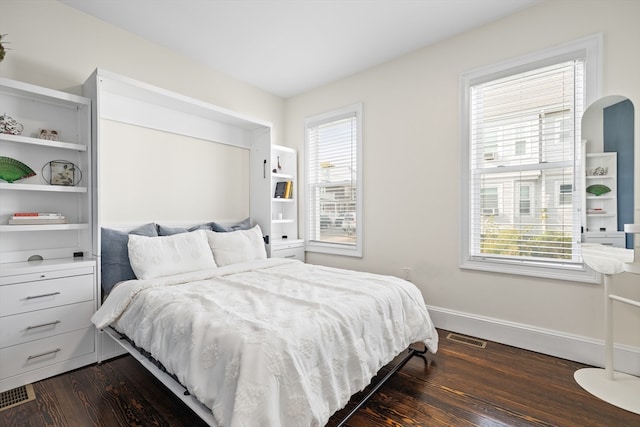 bedroom featuring dark hardwood / wood-style flooring