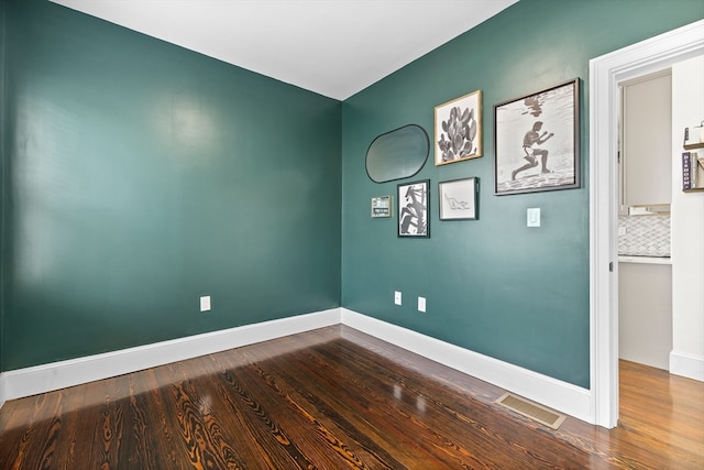 spare room featuring hardwood / wood-style floors