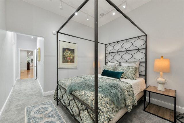 bedroom with carpet floors and rail lighting