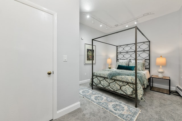 bedroom featuring carpet floors and rail lighting