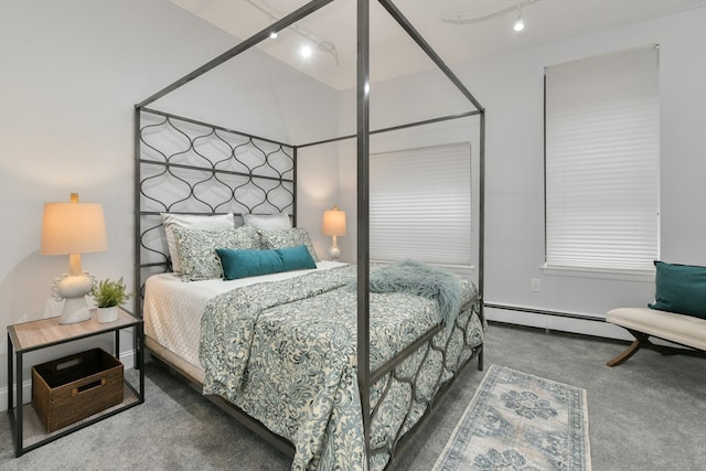 bedroom featuring track lighting, dark colored carpet, lofted ceiling, and baseboard heating