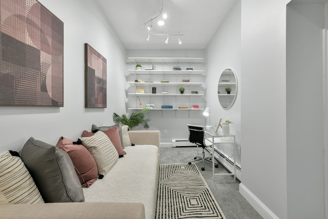 carpeted home office featuring a baseboard heating unit