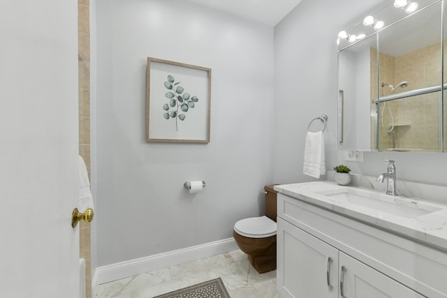 bathroom with a tile shower, vanity, and toilet