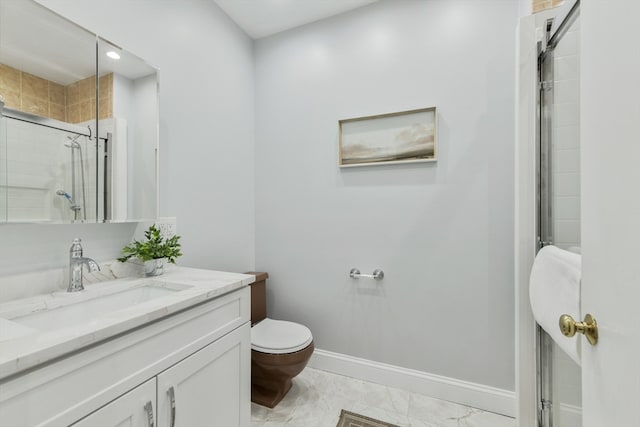 bathroom featuring vanity, toilet, and a shower with shower door