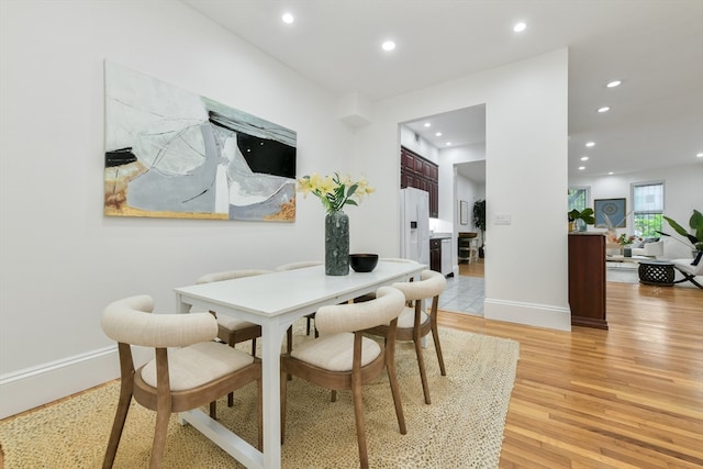 dining space with light hardwood / wood-style floors