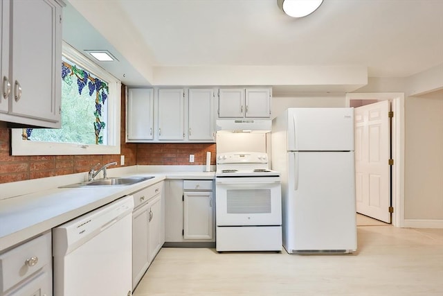 118 Coolidge St, Swansea, MA 02777 - kitchen with white appliances, under cabinet range hood, decorative backsplash, light countertops, and light wood-style flooring