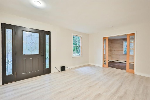 118 Coolidge St, Swansea, MA 02777 - entrance foyer with wood finished floors and a baseboard radiator