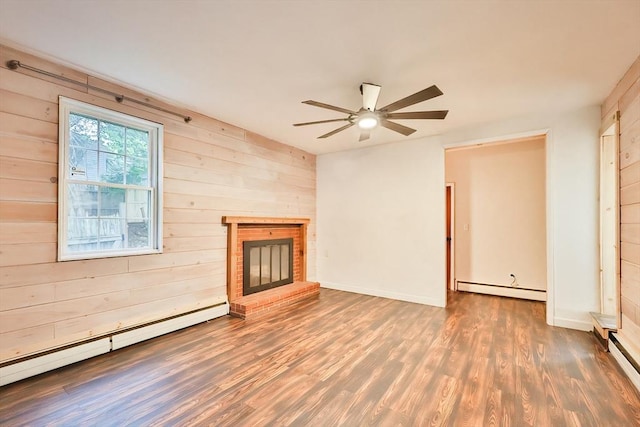 118 Coolidge St, Swansea, MA 02777 - unfurnished living room with a baseboard radiator, wood finished floors, ceiling fan, wooden walls, and a brick fireplace