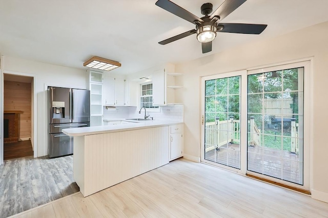 118 Coolidge St, Swansea, MA 02777 - kitchen featuring stainless steel fridge, open shelves, a peninsula, light countertops, and light wood-type flooring