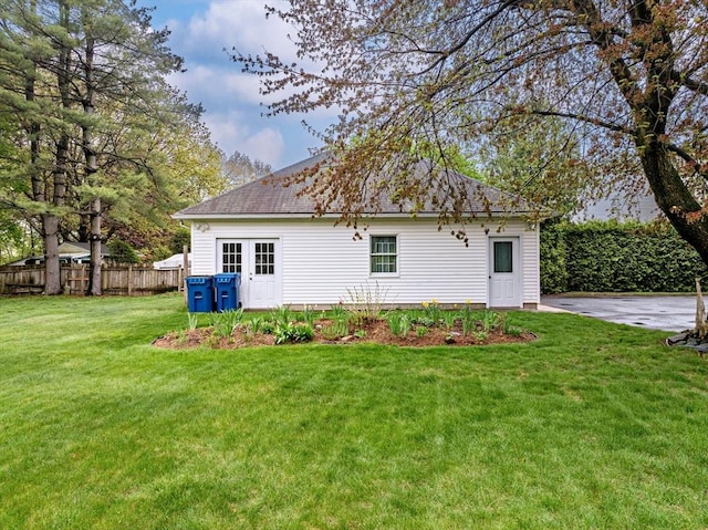 back of property with a yard and fence