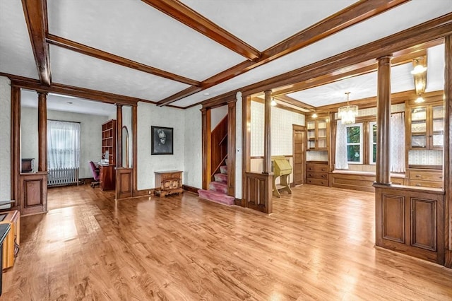 living room featuring light wood finished floors, decorative columns, and plenty of natural light