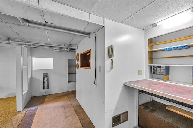 below grade area with carpet flooring and visible vents