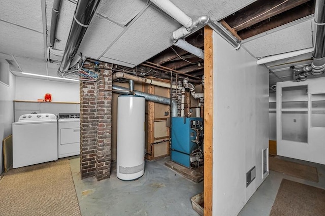 below grade area featuring washer and dryer, water heater, and a heating unit