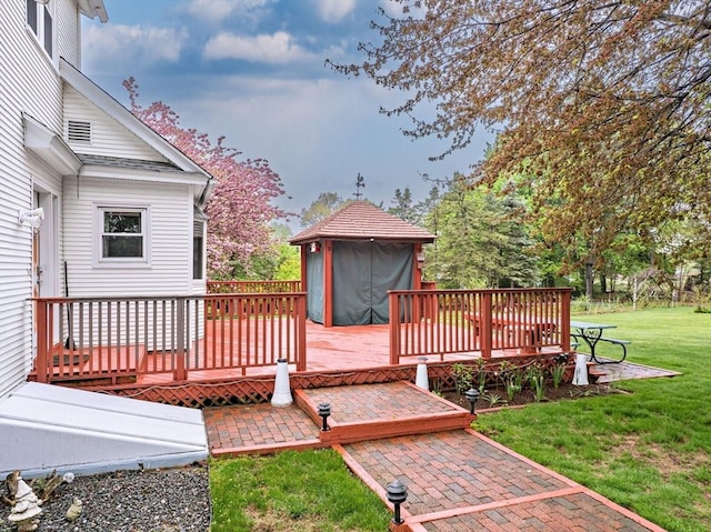deck with a patio and a lawn