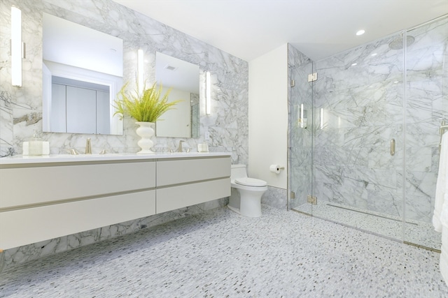 bathroom with vanity, a shower with door, and toilet