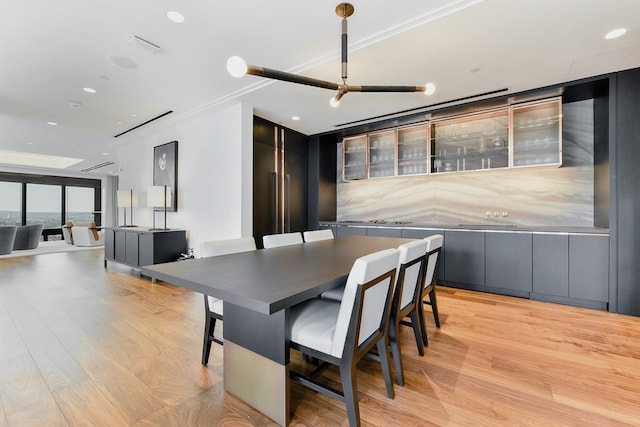 dining space featuring a wall of windows and light hardwood / wood-style flooring