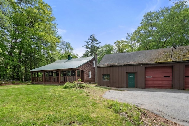 24 Webber Rd, Brookfield, MA 01506 - view of front of property featuring a front yard, driveway, metal roof, and a garage