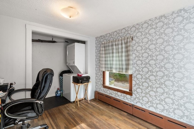 24 Webber Rd, Brookfield, MA 01506 - office area with stacked washer / dryer, a baseboard radiator, wallpapered walls, wood finished floors, and a textured ceiling