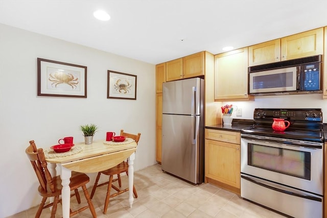 51 Melrose St Unit 5A, Melrose, MA 02176 - kitchen with appliances with stainless steel finishes, dark countertops, light brown cabinetry, and recessed lighting