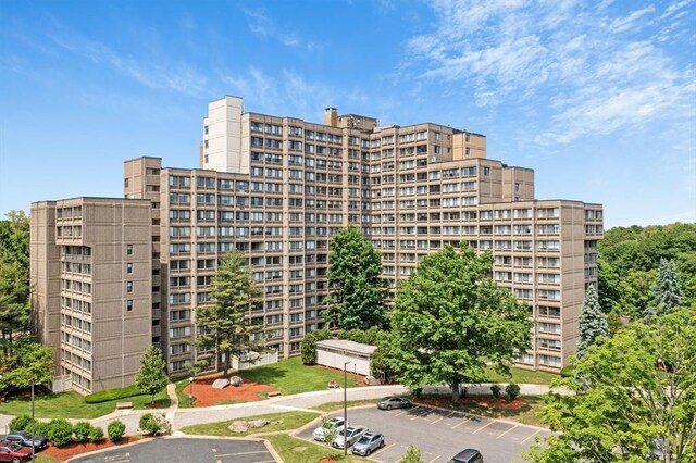 view of apartment building / complex featuring uncovered parking