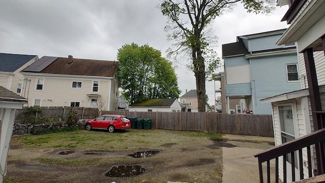 view of yard featuring a fenced backyard and a residential view