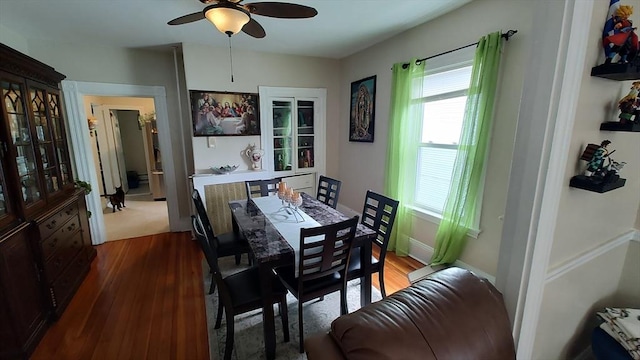 dining space featuring ceiling fan, wood finished floors, and a healthy amount of sunlight