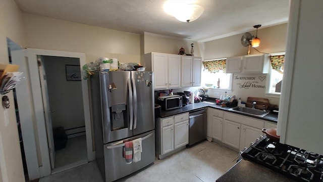 kitchen featuring a baseboard heating unit, a sink, white cabinetry, dark countertops, and stainless steel appliances