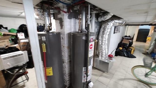 utility room featuring water heater and gas water heater