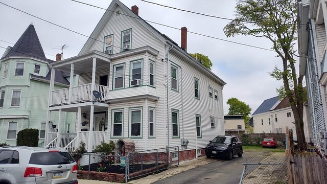 view of front facade with fence private yard and a chimney