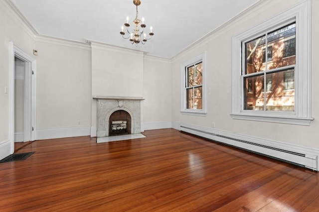 43 Baldwin St, Boston, MA 02129 - unfurnished living room featuring baseboard heating, a chandelier, wood finished floors, crown molding, and a fireplace with flush hearth