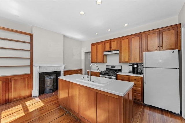 43 Baldwin St, Boston, MA 02129 - kitchen featuring freestanding refrigerator, gas range, under cabinet range hood, brown cabinetry, and recessed lighting