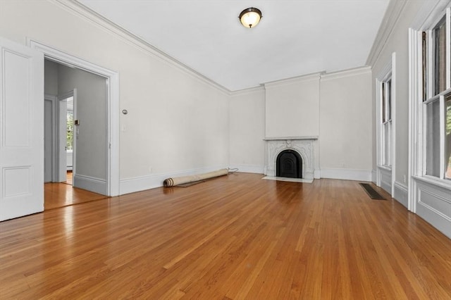 43 Baldwin St, Boston, MA 02129 - unfurnished living room featuring light wood-style floors, a fireplace with flush hearth, and crown molding