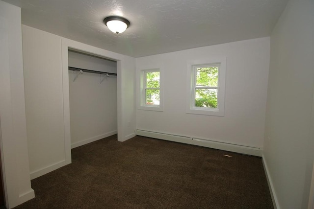 396 Maple St, Winchendon, MA 01475 - unfurnished bedroom with baseboard heating, dark colored carpet, and a closet