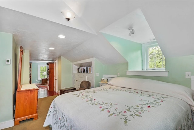 bedroom featuring hardwood / wood-style floors and lofted ceiling