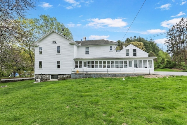 back of property with a lawn