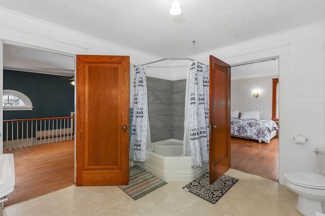 bathroom featuring shower / bath combo with shower curtain, toilet, tile floors, and crown molding