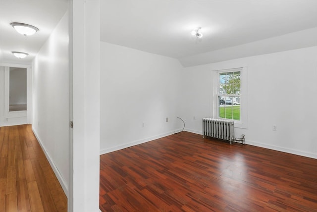 empty room featuring wood-type flooring and radiator