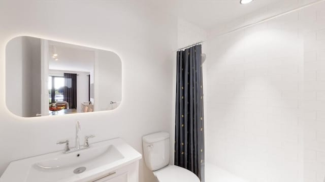 bathroom with a shower with shower curtain, vanity, and toilet