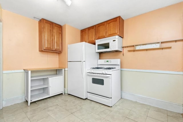 kitchen with white appliances, baseboards, brown cabinets, open shelves, and light countertops