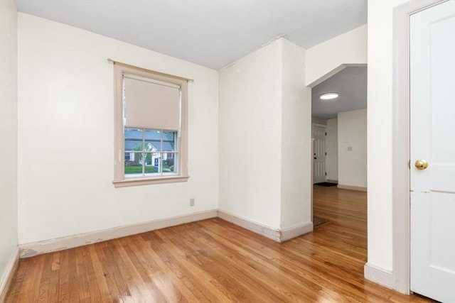spare room with light wood-style flooring and baseboards