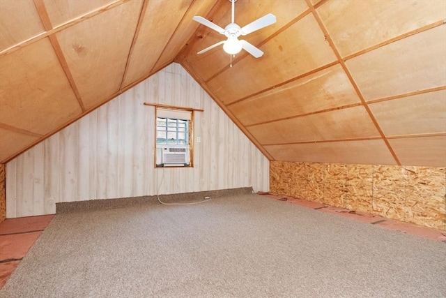 additional living space with carpet flooring, cooling unit, vaulted ceiling, ceiling fan, and wood walls