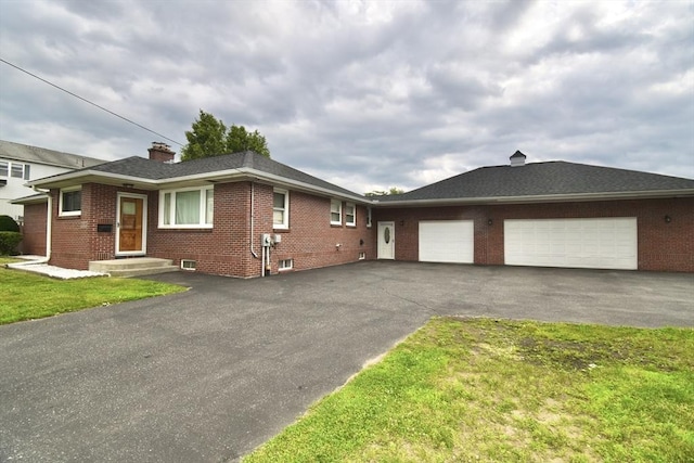 541 Grattan St, Chicopee, MA 01020 - view of side of property featuring brick siding, an attached garage, asphalt driveway, a chimney, and a lawn