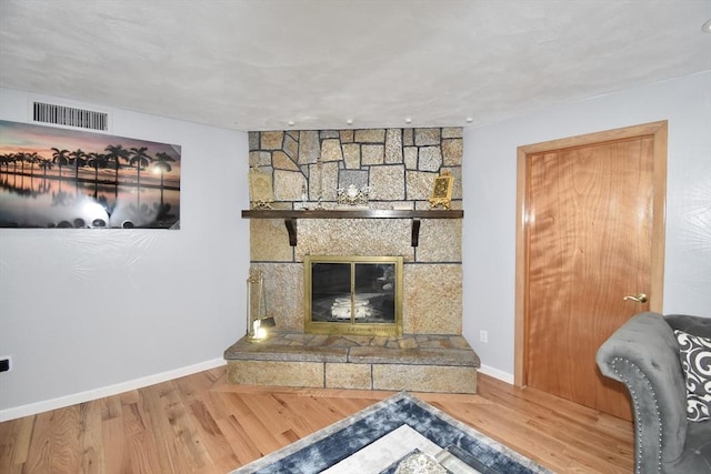 541 Grattan St, Chicopee, MA 01020 - unfurnished living room with wood finished floors and a stone fireplace