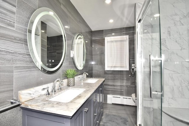 541 Grattan St, Chicopee, MA 01020 - full bath featuring a baseboard heating unit, double vanity, a shower stall, tile walls, and recessed lighting