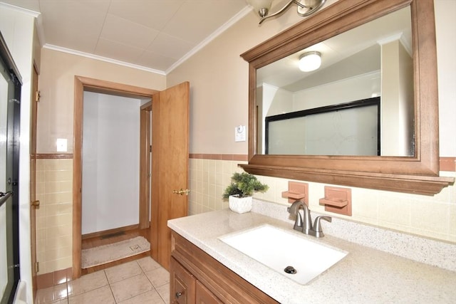 541 Grattan St, Chicopee, MA 01020 - bathroom featuring vanity, tile walls, ornamental molding, tile patterned flooring, and a wainscoted wall