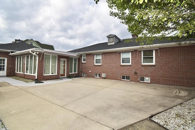 541 Grattan St, Chicopee, MA 01020 - back of property featuring a patio area, brick siding, and a shingled roof